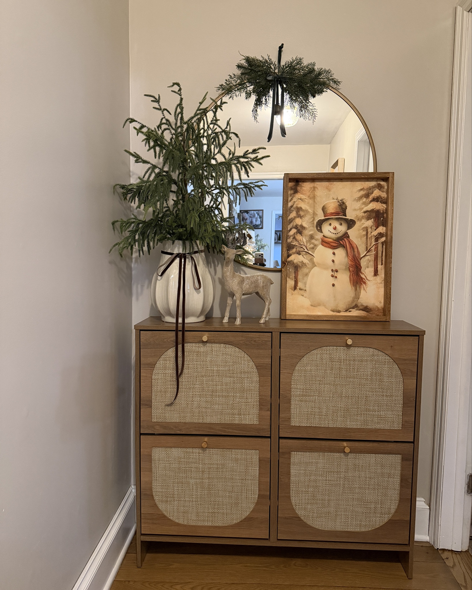 ❄️✨ A little holiday warmth as you walk in ✨❄️
This adorable snowman print from @currentlychichome brings all the nostalgic Christmas charm, and my @nicetree shoe cabinet is keeping this spot organized and cute for the season. Cozy, festive, and functional — just how I like it. 🎄🫶

#LTKHoliday #LTKHome #LTKSeasonal