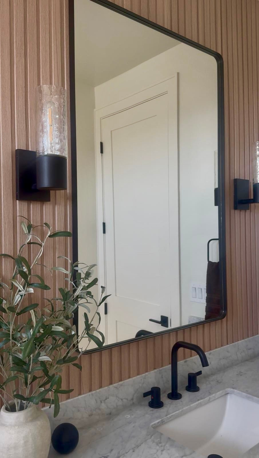 I found this RH-inspired mirror for a fraction of the price, and it gives the same clean, tailored look.

I like how the slim frame softens the vertical paneling and pairs easily with matte black fixtures for a cohesive, elevated finish.

It’s currently on sale, which makes it an easy upgrade if you’ve been wanting a simple bathroom refresh.
@Wayfair
@Target 

 #LTKU #LTKHome #LTKSaleAlert