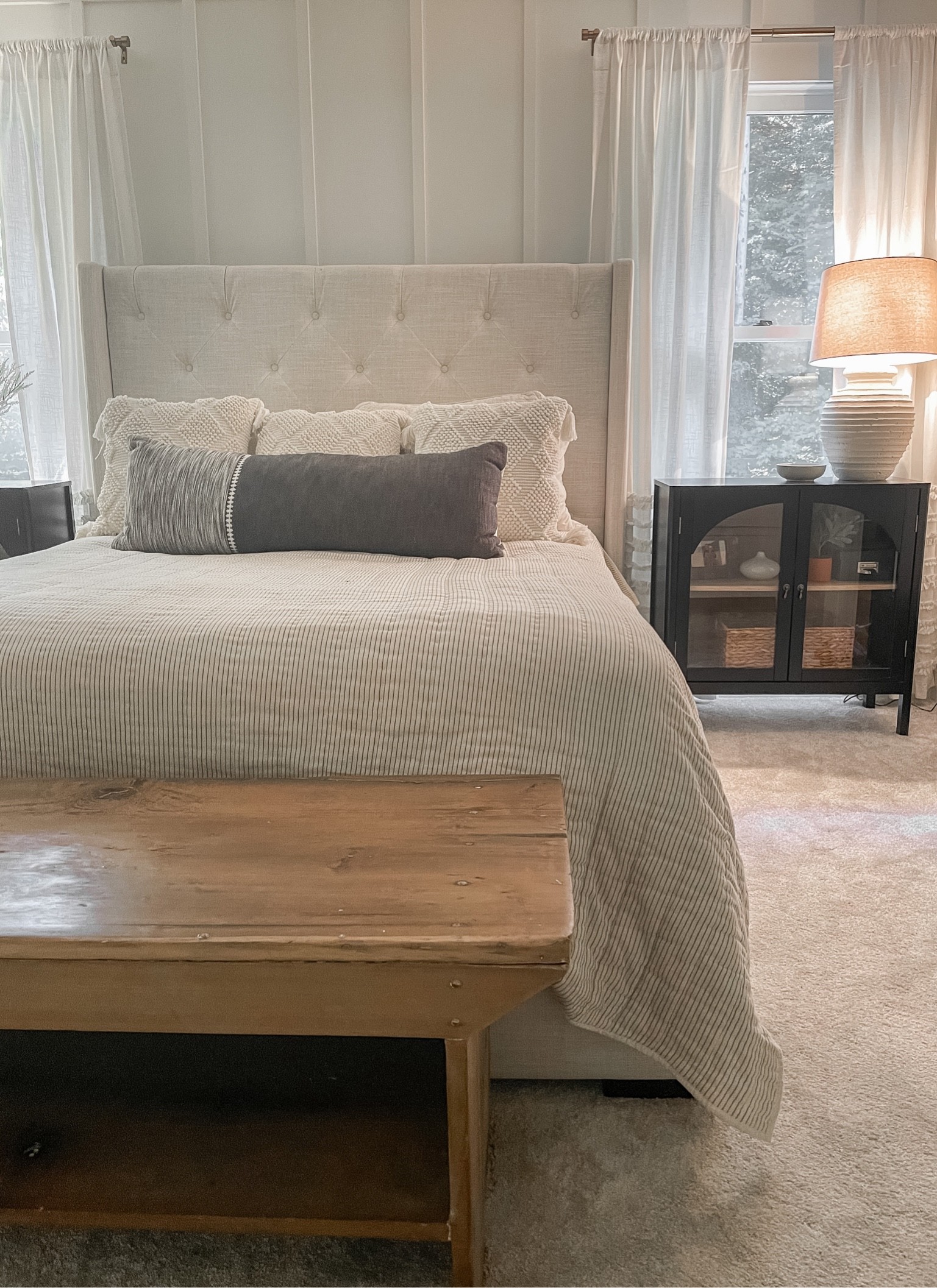 Neutral master bedroom.  Queen quilt.  Target style home.  Throw pillows.  Target lumbar pillow.  Linen tufted headboard.  Luxury sheets bedding.  Wayfair upholstered linen headboard #wayfair Target black bedside table.  Black arched cabinet.  White ruffle curtains 


#LTKhome #LTKunder100 #LTKfamily