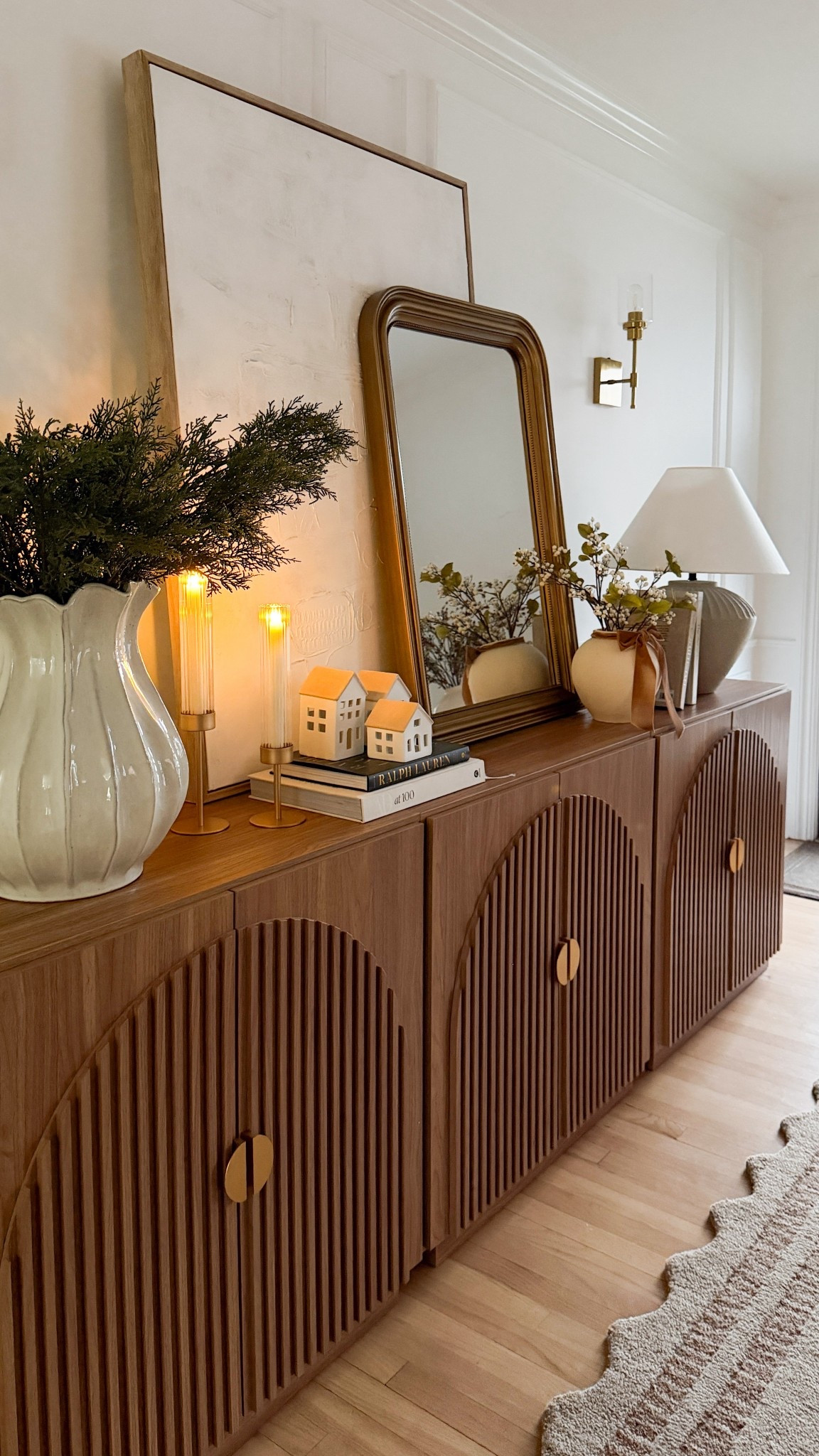 My new entryway is finally complete, and I’m in love with how everything turned out! ✨🤍🌲 I’ve been craving a clean, classic holiday vibe this season, and this piece fluted sideboard is both gorgeous and so functional ( I added 3 pieces to get this look) 
I love that it hides shoes, stores bags, and keeps all the little things tucked away so the space stays fresh and styled. 

#LTKHome #LTKHoliday #LTKSaleAlert