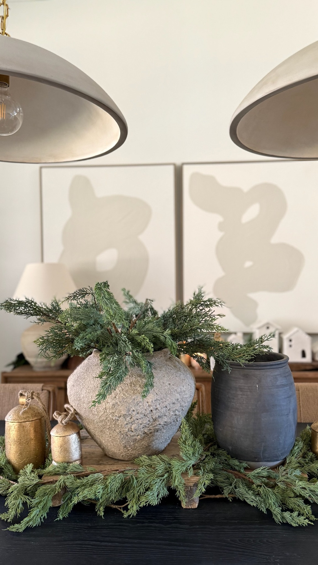 Vintage gold bells, lush greenery, and black velvet bows — the easiest way to elevate your dining room table this holiday season. The tall greenery adds height and drama! All of our favorite interior holiday decor is already linked on our LTK.

Need help designing your home to feel holiday-ready? Check out our e-design packages at porcheandco.com/edesign — we’d love to work with you. 

 

#LTKHoliday #LTKSeasonal #LTKHome