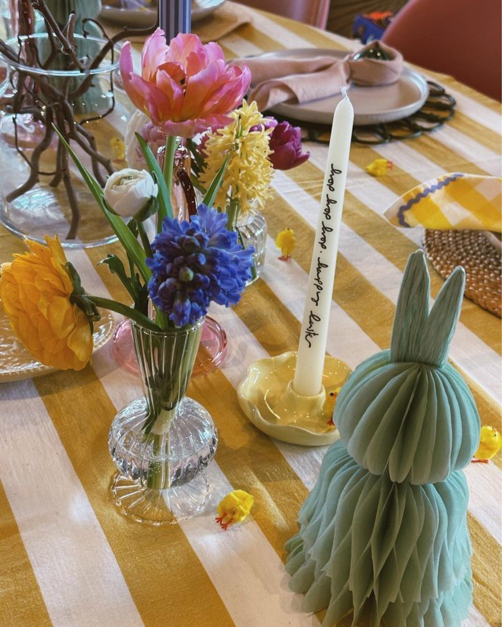 Easter decor, striped yellow table cloth, flower decor, vase, stick candle, table decor, plates 

#LTKFind #LTKhome #LTKSeasonal