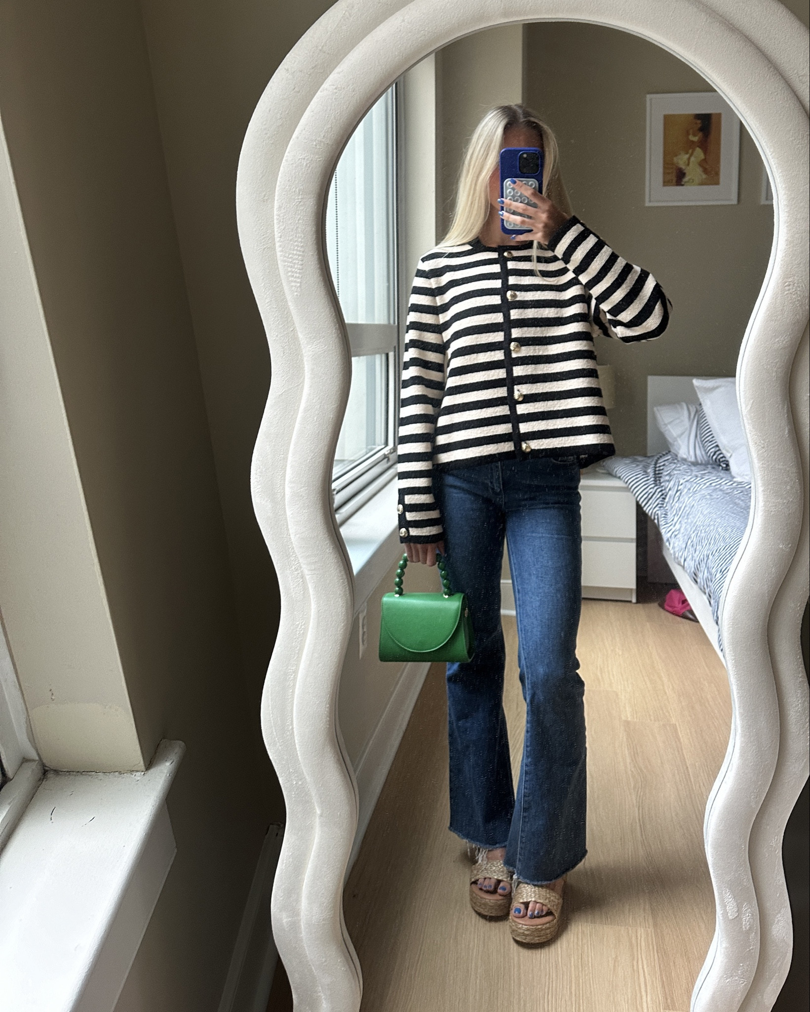 Striped button down sweater with flare blue jeans and green purse with summer sandal 

#LTKSeasonal #LTKfindsunder100 #LTKstyletip