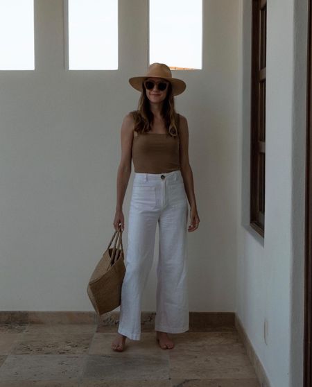 A vacation outfit I love 🤎 white linen-ish pants paired with a nude cami and straw accessories.

Exact pants are (old) Rolla’s 
