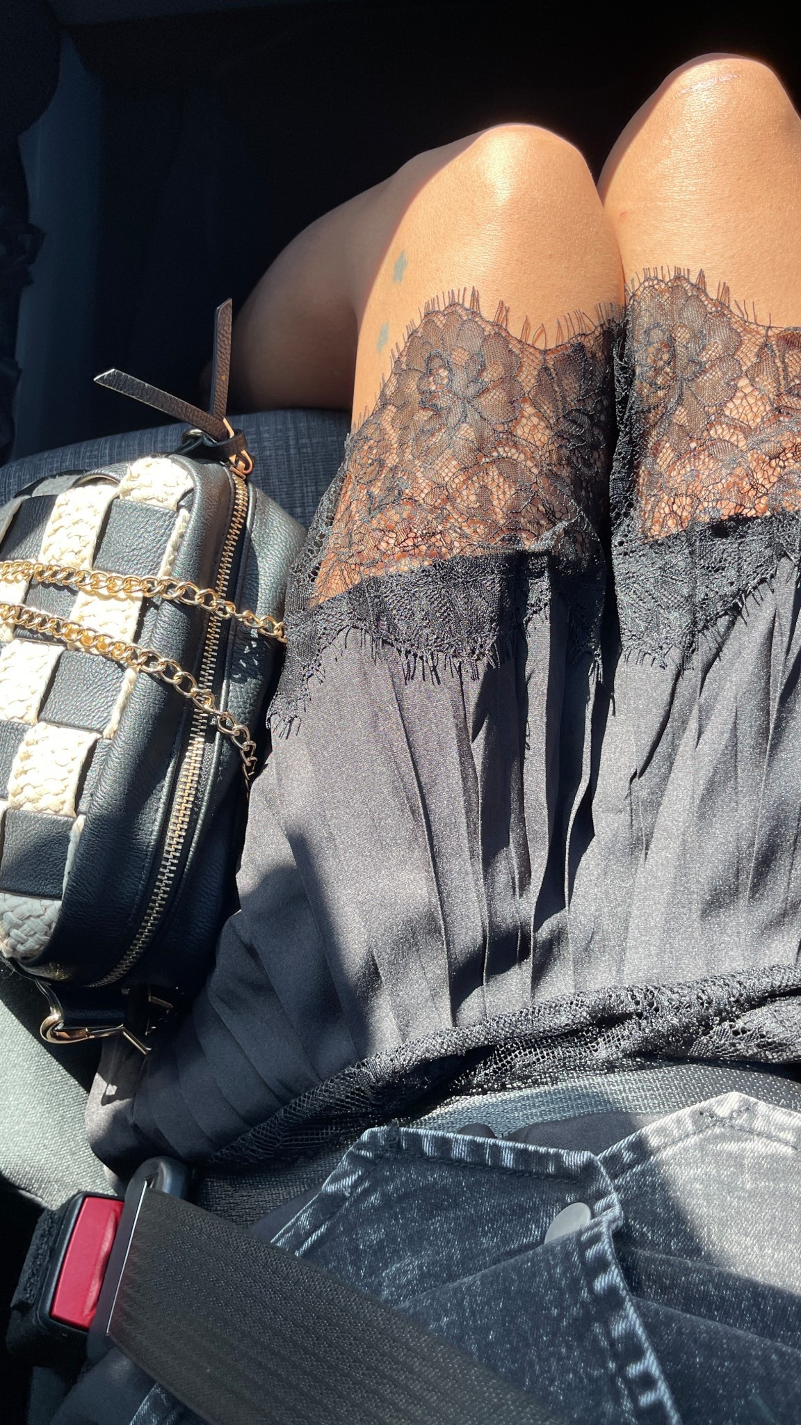Pleated black lace slip skirt and dark denim vest