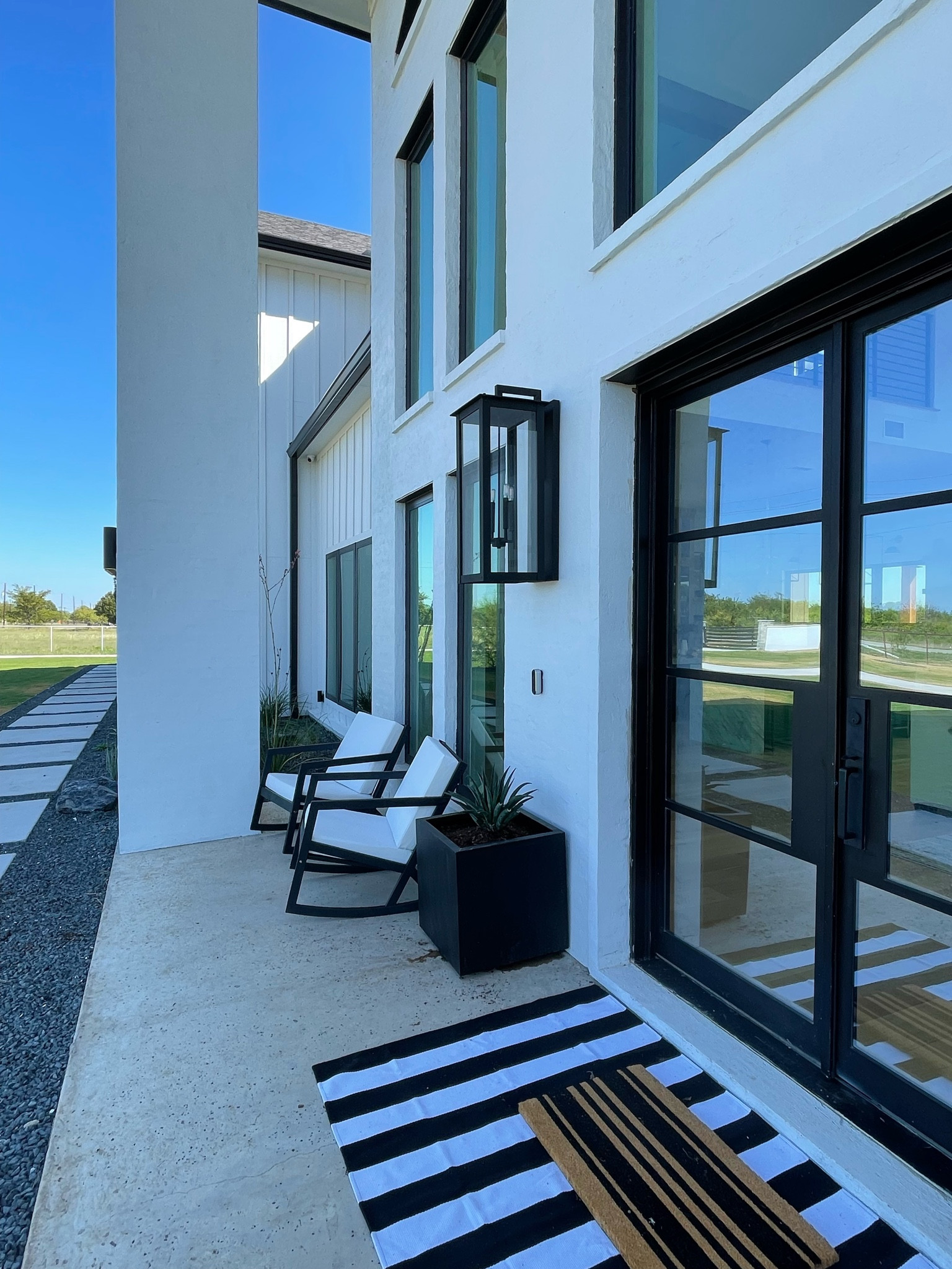 Front porch seating and planters definitely spruce up this area.  A black and white palette is timeless and easily transitions from season to season.

#LTKSeasonal #LTKhome #LTKSale