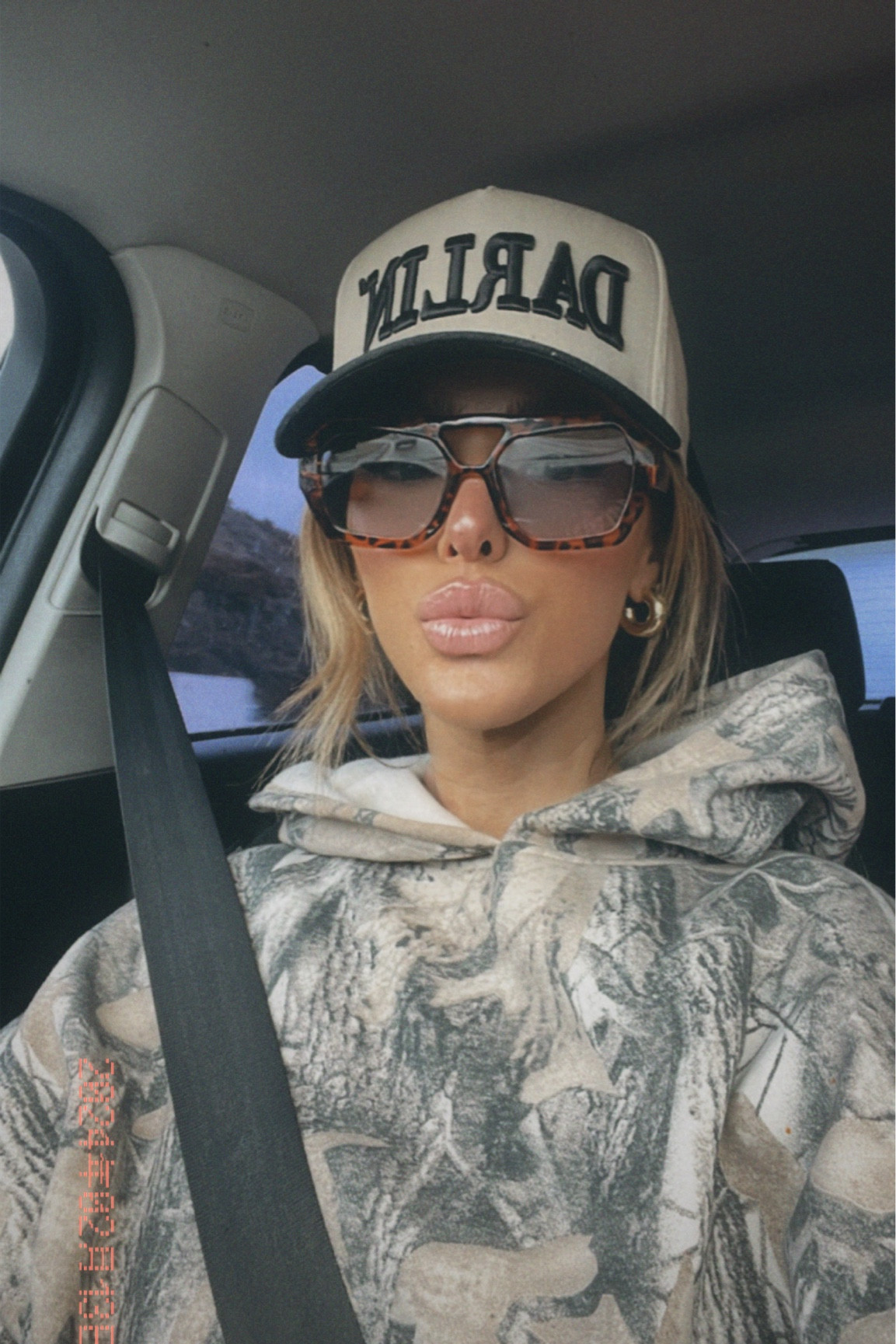 Camo hoodie, DARLIN trucker hat, blue shade sunglasses 