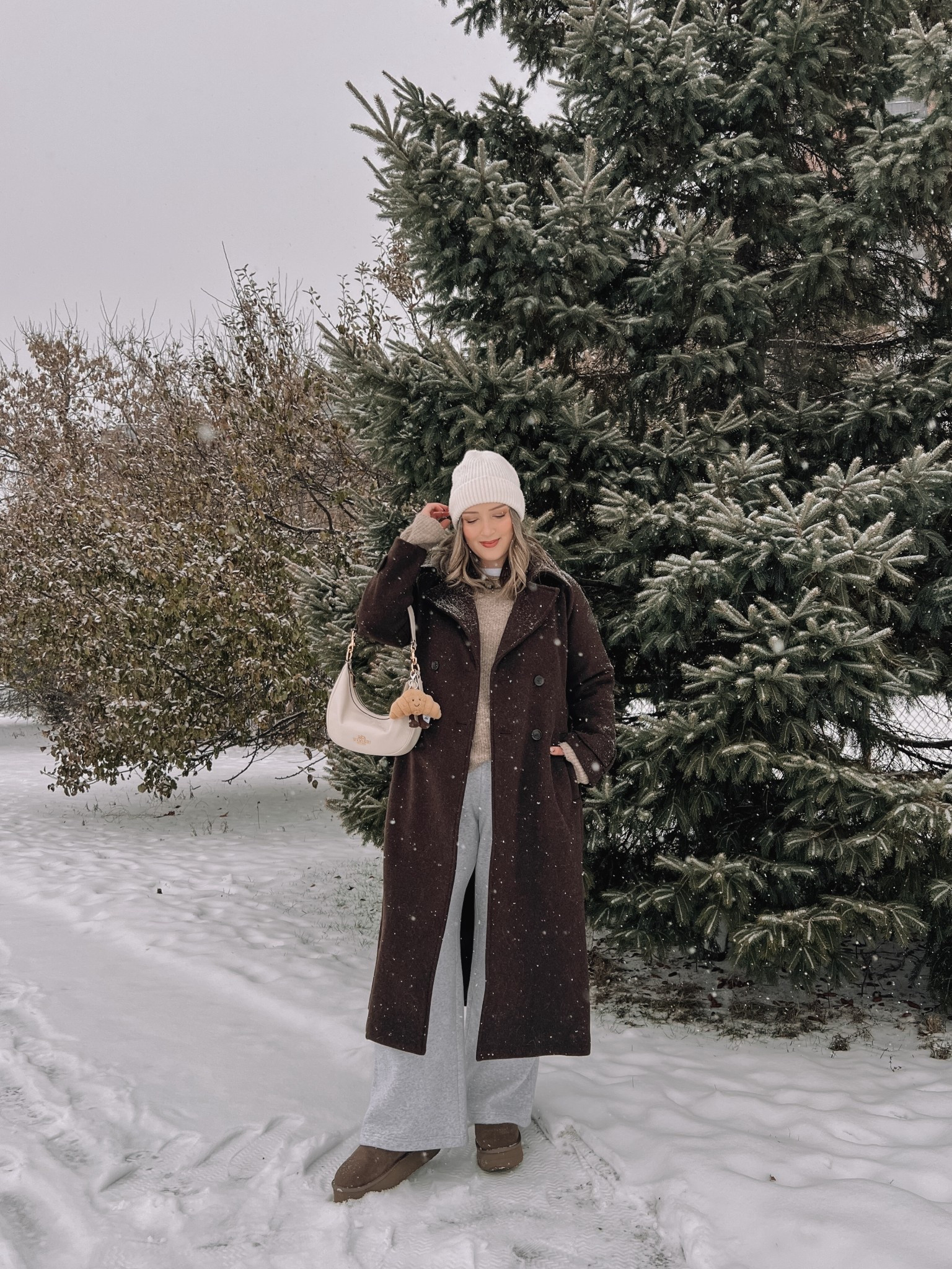 Cozy winter outfit! Wearing my usual size L in the chocolate brown wool trench coat - it’s so warm and such a good staple piece! Also wearing L in the wide leg sweatpants, these are thick and cozy and cute enough to wear out! This white tee is my fave for layering since the neck is higher, wearing my usual size L. My Ugg style boots are Amazon and such good quality! I’m usually a 9.5-10 and wear a 10 in these. Linked similar neutral sweaters & cream beanie


#LTKmidsize #LTKsale #LTKwinter