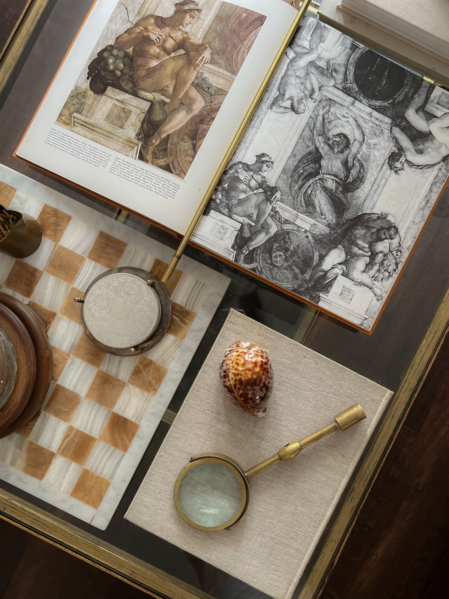 Collected coffee table decor - tiger cowrie shell, silver plate coasters, marble chess board, brass magnifying glass, vintage, antique

#LTKHome #LTKFindsUnder100 #LTKFindsUnder50