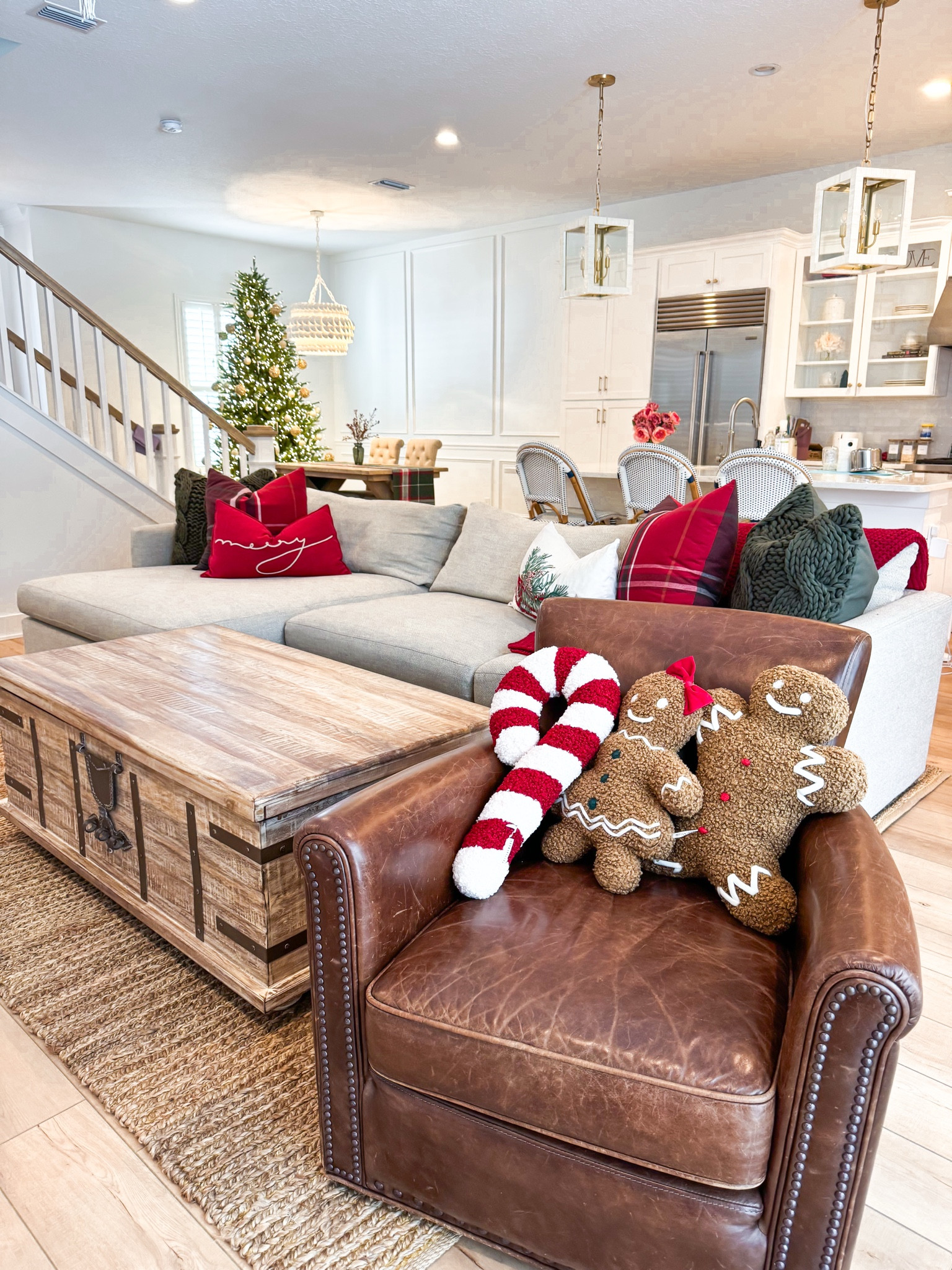 Pottery barn gingerbread pillows. Pottery barn Christmas pillows. Living room. Pottery barn coffee table. Dining room. Neutral furniture. Coastal home decor. Neutral decor. Pottery Barn chest coffee table (love the storage inside)! Pottery Barn dining room table. Driftwood furniture. Pottery Barn leather swivel chair. Serena and Lily Riviera counter stools (so easy to clean!!). Crate and Barrel couch - 2-Piece – Left-Arm Chaise + Right-Arm Sofa configuration in Taft pearl! Serena and Lily pendant lights. Serena and Lily chandelier. 

#LTKHome #LTKSeasonal #LTKHoliday