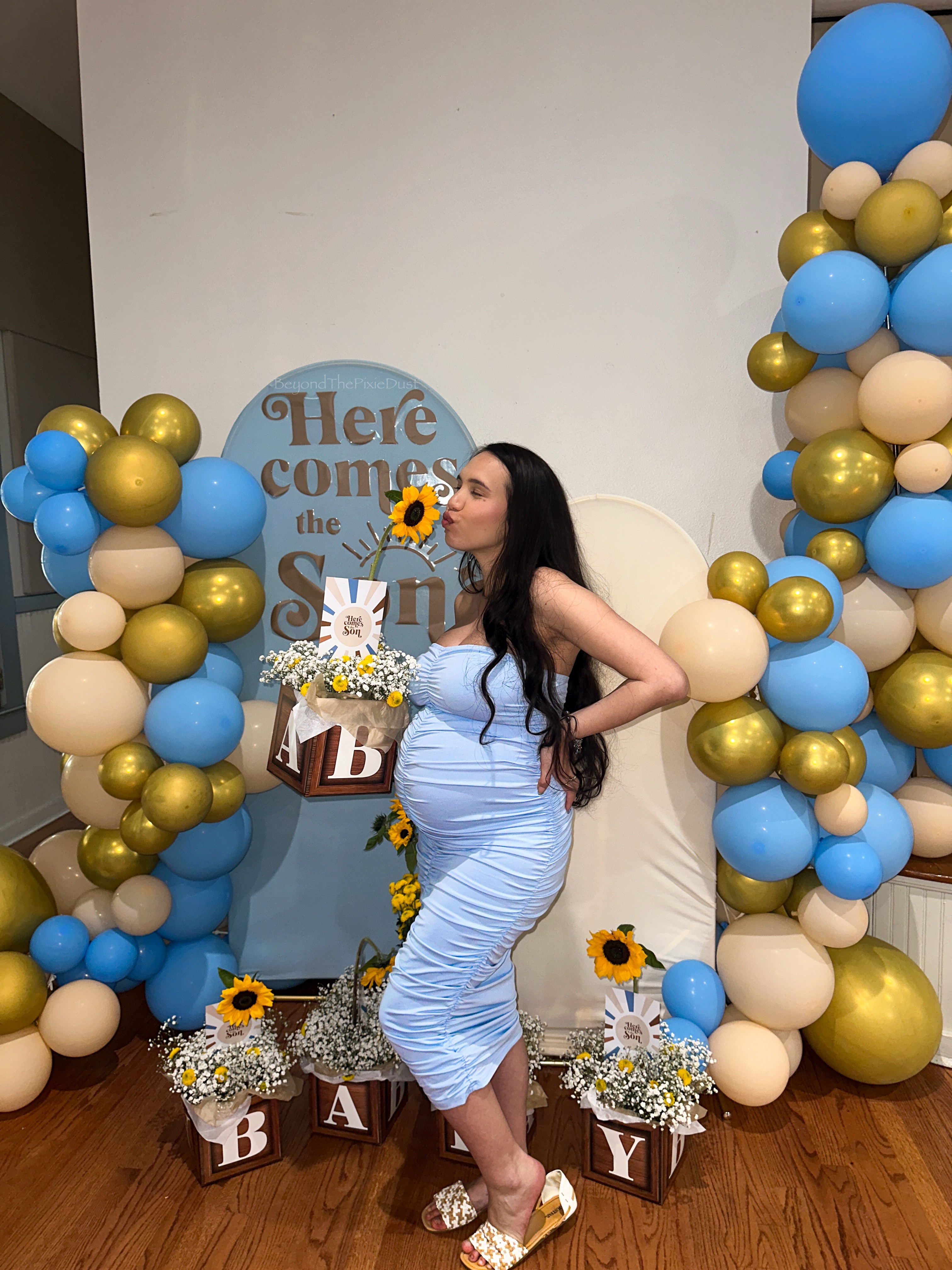 I had a "Here Comes the Son" theme for my baby shower, and it turned out exactly as I envisioned! I initially struggled to find a color scheme that I liked until I came across a “Here Comes the Son” sign on Amazon. I decided on wooden brown tones, blue, and gold to represent the sun for the balloons. 
✨
For the table centerpiece, I found some “baby” boxes on Amazon and incorporated tissue paper, baby’s breath, and sunflowers, which came together beautifully. I also DIYed a few things and linked all the items I used, including the dress I wore from Shein, my Apple Watch case, and my makeup. I hope this inspires you for your own baby shower or that of a loved one!

#LTKBump #LTKBaby #LTKParties