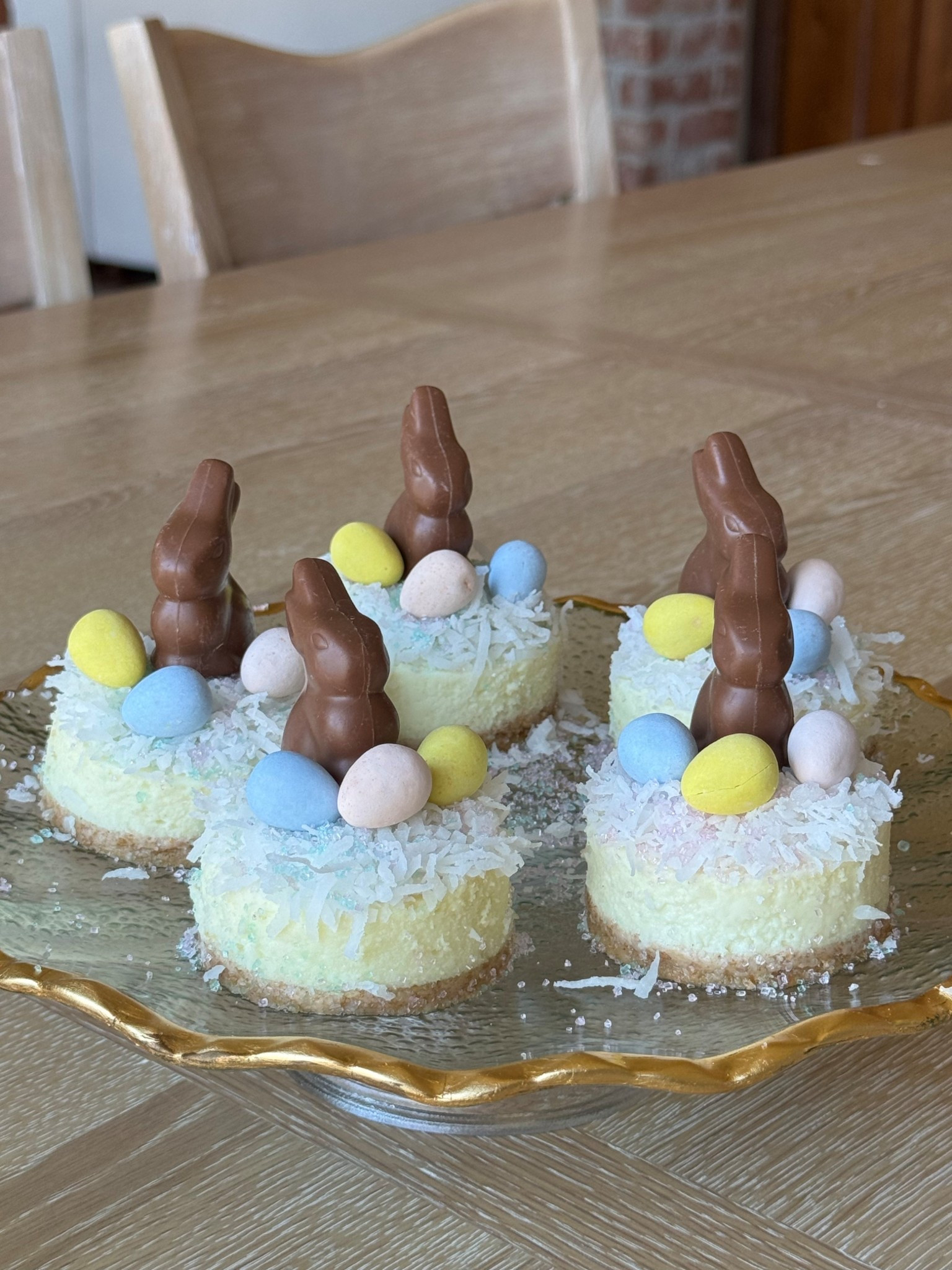 Easter cheesecake bites! How cute are these!? So easy and entertaining. Ingredients: Walmart plain New York Style cheesecake, shredded coconut flakes, mini chocolate bunny, colorful mini chocolate eggs.  Using a circle cookie cutter, cut your cheesecake. Add shredded coconut, sprinkles, bunnies then eggs. Enjoy! 

#LTKHome #LTKfoodie