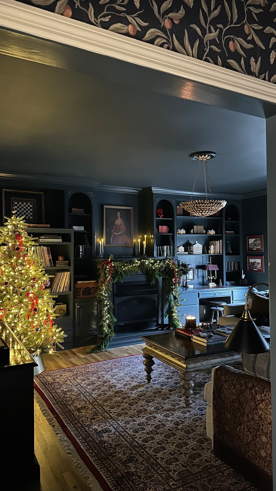 Traditional inspired Christmas in my cozy tv room. A dark color palette, red bows, nutcrackers, tartan, candles, crystal decor, and traditional garland and Christmas tree give this room a classic Christmas feel. #interiordesign #christmasdecor #ralphlauren #holiday #moody 

#LTKHoliday #LTKHome #LTKSeasonal