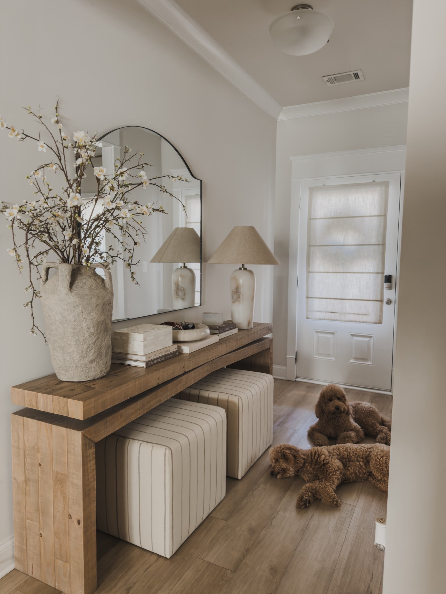 #AD @Wayfair finds in my entryway. I’ve been really intentional about choosing pieces that feel elevated but still make sense for how we actually live day to day.

My solid wood entry table is one of those forever pieces — such beautiful quality and it instantly makes the space feel more custom. I also found a look for less option that I own and love, and it gives a really similar feel without the higher price point. And my neutral striped ottomans add the perfect layer of texture while still keeping everything light and cohesive. If I were to repurchase, I would definitely go with the storage option… always thinking function first.

@wayfair #wayfair #wayfairpartner 


#LTKSeasonal #LTKHome #LTKSaleAlert