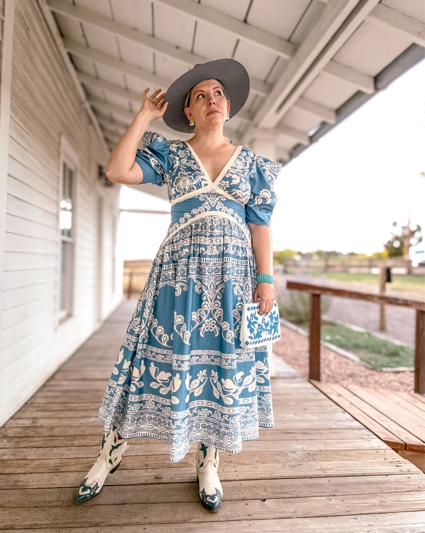 Look 11 - Desert Dust 🌵 
A curated capsule series 

This dress has made appearances in a few of my capsules now, and it continues to surprise me with just how versatile it is. At first glance, it feels like such a statement piece but I’ve been able to style it so many different ways (and have even more ideas up my sleeve 👀). It’s the perfect reminder that accessories truly make the outfit.

Lately, I’ve been thinking about the difference between wearing and styling. Some people interpret styling as manipulating or changing a piece, but to me, it’s about how you use the accessories - the bag, the shoes, the hat, the jewelry - to shape the story your outfit tells. My background in costume design taught me that it’s those little details that give meaning, turning a great garment into a full expression of self.

The Desert Dust capsule has been my playful, colorful take on Western style - blending heritage details, bold hues, and preppy fun. Each of my capsules is a themed mini-collection that explores a different world of style through two weeks worth of looks.

✨ Follow along to join the fun - the next capsule starts tomorrow!

Dress - Farm Rio (rent from Nuuly & get $30 off with my link below.)
Boots - Acme (Vintage) (a couple pairs linked)
Hat - Wyeth (linked)
Bag - Sincerely Jules (linked)
Bracelet - Rocksbox
Earrings - Lele Sadoughi (similar linked)
Ring - Vintage (similar linked)

Get $30 off of your first month of Nuuly: https://share.nuuly.com/kat42828

#DesertDustCapsule #FarmRioLovers #WesternInspired #CapsuleWardrobe 

#LTKSeasonal #LTKItBag #LTKStyleTip