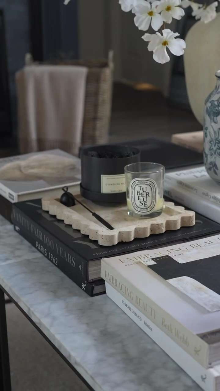 OMG I am absolutely freaking out over this cozy coffee table moment. The stacked neutral design books, the soft blue and white floral ginger jar, and that perfectly melted candle are giving the dreamiest layered home decor vibes. I love creating these calm, curated corners with timeless textures, neutral tones, and classic styling that make a living room feel warm, elevated, and beautifully lived in. EEP this is my kind of interior styling magic. 

 #LTKSpringSale #LTKHome #LTKSaleAlert