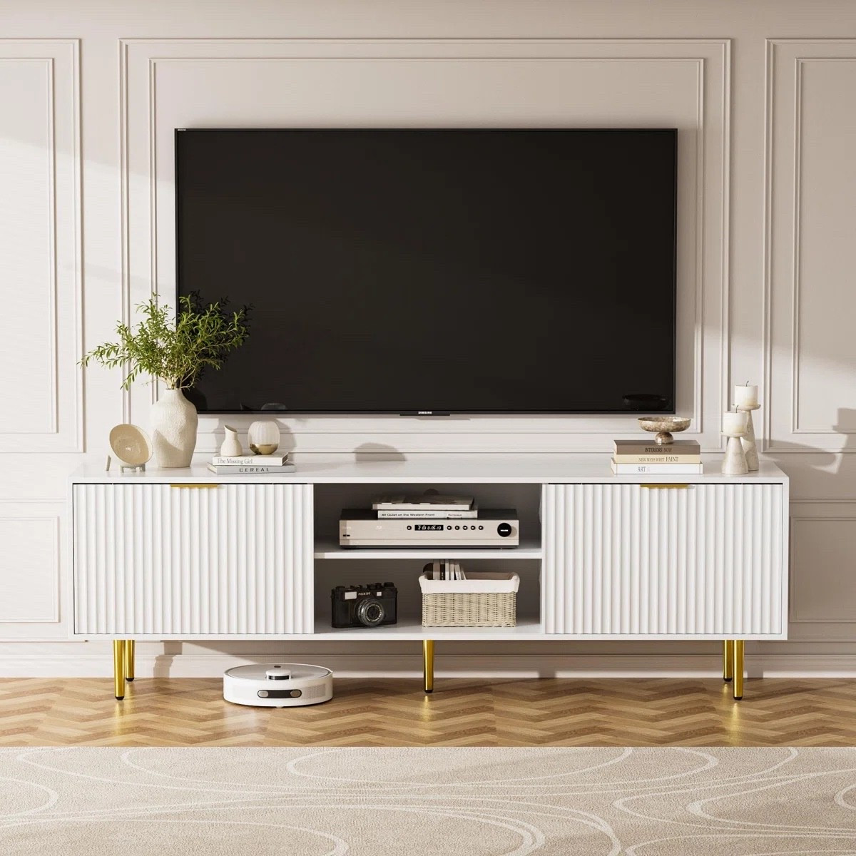 I keep coming back to TV stands like this because they make the whole living room look more finished without trying too hard. This white TV stand from Wayfair has fluted cabinet doors, open media shelves, gold-tone legs, storage for hiding the random living room stuff, and cable management in back. Love it with the mounted TV, soft neutral rug, stacked books, and a simple vase with greenery. Such a pretty setup for movie nights and everyday lounging.