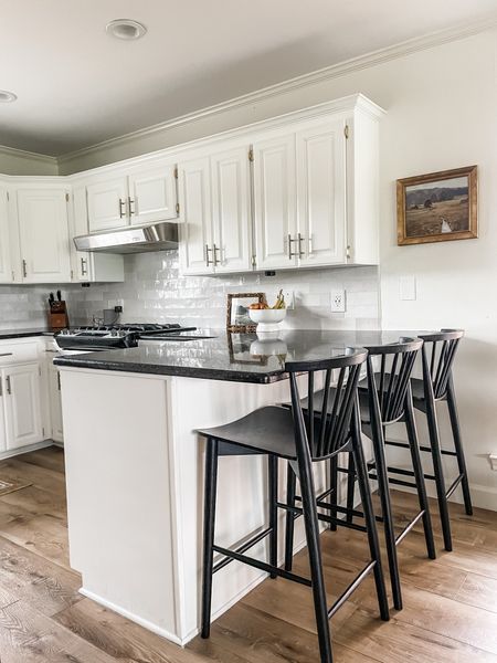 A bright and airy kitchen that once felt dark and heavy. We painted cabinets in Benjamin Moore Swiss Coffee, added backsplash from Lowe’s and added gold hardware to the cabinets. The Poly and Bark bar stools were a perfect addition to this family kitchen. 

#LTKhome #LTKfamily