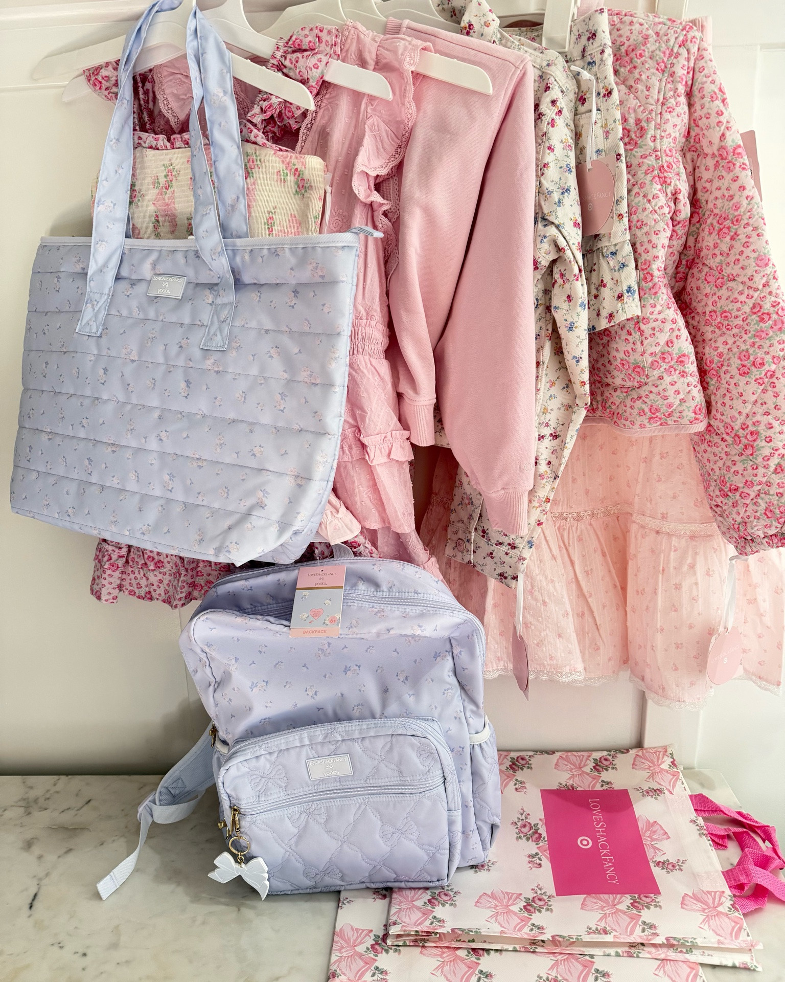 Happy Tuesday!☺️ Last package arrived & here’s my @target @loveshackfancy order from online last weekend with the cute backpack & tote that I got last Sunday when I went to 2 Targets!!🎯🤩 I love the adorable details of bows, lace, ruffles, and the floral prints are so pretty!!💗🎀😍 These are what made it and my thoughts on them!!🥰 The first on the list if anything worth getting is the denim floral jacket with the matching skirt that’s got a ruffle hem and adjustable waist!!💐☺️ Second is the tiered ruffle dress with embroidered roses, it’s so pretty in pink!!🩷😄 Third, is the quilted barn jacket with a beautiful rose pattern with corduroy collar & trim!!😍 It’s lightweight, perfect for summer to transition into fall with!!☺️ Fourth, would be the pink pullover that has an appliqué embroidered lace bow to match the soft pink maxi tiered skirt with Swiss dot fabric that has lace & bow to accents!!😍 The smocked dress with ruffle straps and tiered ruffles with bows is so cute, ran big and a little short!☺️ Everything ran slightly bigger than TTS. I ordered the largest size in both jackets and the lace bow pullover to last her a couple of years because she loved them so much!!🥰 The maxi skirt ran very big and can size down 1-2 sizes. Last, the backpack with clip on bow charm & matching tote are both in a pretty lavender floral print with gold bow on the zipper pulls that my daughter loves!!💜😍 Aren’t these all perfect for back to school?🤔

#LoveShackFancyxTarget #newattarget #backtoschool #girlsdresses #targetdress #backpack

#LTKKids #LTKootd #LTKmomlife